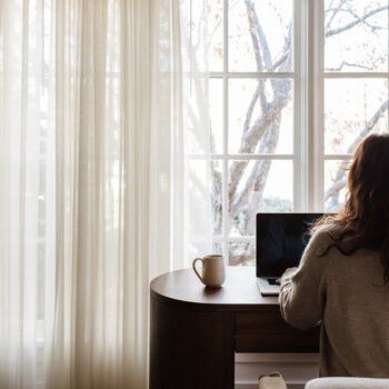 business owner sitting at computer reviewing business documents and estate plans