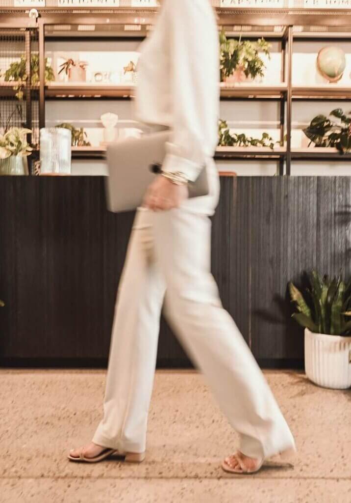 Marne, founder of Legacy Bridge Legacy, holding laptop