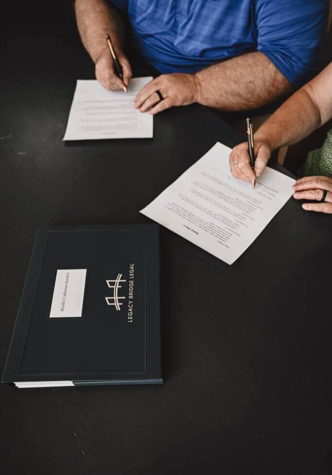 Legacy Bridge Legal clients signing paperwork